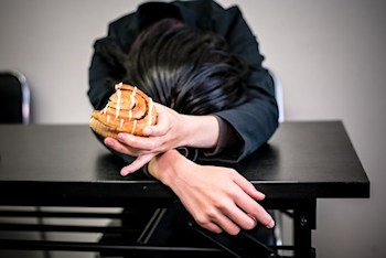 head down holding a donut