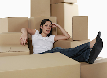 woman surrounded by packing boxes